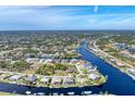 Bird's eye view of waterfront community with houses and canals at 9303 Migue Cir, Port Charlotte, FL 33981