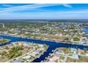 Community overview featuring canal-front properties and lush greenery at 9303 Migue Cir, Port Charlotte, FL 33981