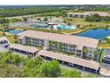 Aerial shot of condo community featuring multiple buildings, parking, and tennis courts at 175 Kings Hwy # 1014, Punta Gorda, FL 33983