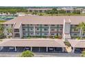 Condo with covered parking, colorful trim, and maintained landscaping at 175 Kings Hwy # 1014, Punta Gorda, FL 33983