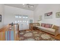 Bright living room with high ceilings and hardwood floors at 13044 Via Cassia, Placida, FL 33946