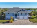 Waterfront home with spacious driveway and large garage at 13044 Via Cassia, Placida, FL 33946