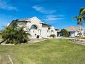 House exterior with landscaping and palm trees at 8 Sportsman Ter, Rotonda West, FL 33947