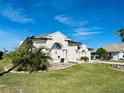 House exterior showcasing manicured lawn and palm trees at 8 Sportsman Ter, Rotonda West, FL 33947