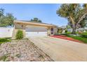Brick driveway leading to a two car garage at 1361 Newton St, Port Charlotte, FL 33952