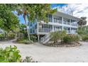 Two-story beach house with private balconies and lush landscaping at 7536 Palm Island S Dr # 1511, Placida, FL 33946