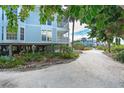 Beach house with a walkway and tropical landscaping, offering privacy at 7536 Palm Island S Dr # 1511, Placida, FL 33946