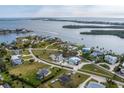 Picturesque aerial view of a coastal community featuring unique homes, lush landscaping, and waterfront access at 342 Green Dolphin Dr, Placida, FL 33946