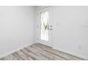 Bright entryway with wood-look flooring and white walls at 8099 Walbert St, Port Charlotte, FL 33981