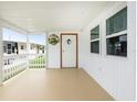 Covered porch with white railings and access to the home at 337 Blackburn Blvd, North Port, FL 34287