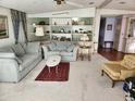 Living room with couches, shelving, and a coffee table at 6276 Oriole Blvd, Englewood, FL 34224