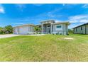 Two-car garage home with nicely landscaped lawn at 9293 Panama Cir, Port Charlotte, FL 33981