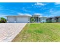 Two-car garage home with a large front yard at 9293 Panama Cir, Port Charlotte, FL 33981