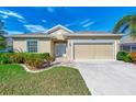 One-story home with attached garage, landscaping, and a paved driveway at 584 Gadsen St, Englewood, FL 34223