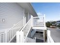 Exterior white stairs leading to a private balcony at 7486 Palm Island Dr # 2424, Placida, FL 33946