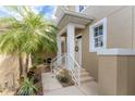 Inviting entryway with lush landscaping and a charming front porch at 10601 Lemon Creek Loop # 102, Englewood, FL 34224