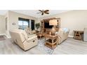 Relaxing living room featuring comfortable furniture and a large TV at 10601 Lemon Creek Loop # 102, Englewood, FL 34224