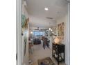 Bright and airy entryway offering a view of the living area and kitchen at 5856 Gasparilla Rd # M31, Boca Grande, FL 33921