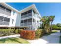 Elevated home exterior with screened porch and landscaping at 7450 Palm Island Dr # 3411, Placida, FL 33946