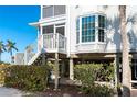Elevated home exterior detail with stairs and landscaping at 7450 Palm Island Dr # 3411, Placida, FL 33946