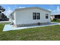 White mobile home with landscaped yard at 8485 Nighthawk Dr, Englewood, FL 34224