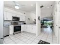 Modern kitchen featuring stainless steel appliances and white cabinetry at 4260 Placida Rd # 9B, Englewood, FL 34224