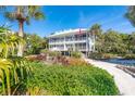 Two-story home with screened porch and lush landscaping at 7536 Palm Island S Dr # 1524, Placida, FL 33946