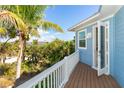 Private deck with wooden flooring and white railings, offering tranquil views of surrounding landscape at 431 Kettle Harbor Dr, Placida, FL 33946