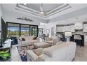 Spacious living room with comfortable seating and access to the kitchen at 14207 Union Hall Ave, Port Charlotte, FL 33981