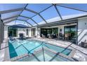 Inviting pool and spa area with covered patio at 14207 Union Hall Ave, Port Charlotte, FL 33981