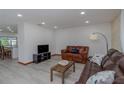 Bright living room featuring a leather sofa and hardwood floors at 578 Lomond Dr, Port Charlotte, FL 33953