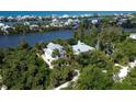 Two waterfront homes nestled amongst lush vegetation at 201 Kettle Harbor Dr, Placida, FL 33946
