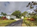 Long driveway leading to a two-car garage and detached garage at 110 S Oxford Dr, Englewood, FL 34223