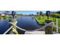 View from dock of canal with lush landscaping at 9194 Impala Cir, Port Charlotte, FL 33981