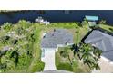 Aerial view of single-Gathering home on canal at 9194 Impala Cir, Port Charlotte, FL 33981