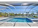 Inviting pool and spa with a covered patio at 8250 Arlewood Cir, Port Charlotte, FL 33981
