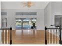 Bright living room with hardwood floors, high ceilings, and sliding glass doors leading to a pool at 26021 Templar Ln, Punta Gorda, FL 33983