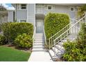 Building exterior with stairs and tropical landscaping at 5850 Gasparilla Rd # M1&3, Boca Grande, FL 33921