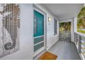 Inviting condo entry with teal door and nautical decor at 6800 Placida Rd # 121, Englewood, FL 34224