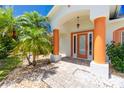 Front entryway with orange columns, a glass door and a brick walkway at 9660 Miami Cir, Port Charlotte, FL 33981