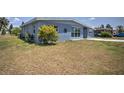Ranch-style home with light blue exterior and a side view at 22216 Midway Blvd, Port Charlotte, FL 33952