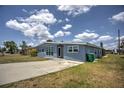 Ranch-style home with light blue exterior and a spacious front yard at 22216 Midway Blvd, Port Charlotte, FL 33952