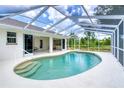 Inviting kidney-shaped pool with screened enclosure and spacious patio at 5039 Parker St, Port Charlotte, FL 33981