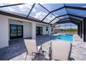 Relaxing pool area with a covered patio and lounge chairs at 10401 Sunday Dr, Port Charlotte, FL 33981