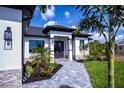 Front entrance of a home with a stone walkway and landscaping at 10401 Sunday Dr, Port Charlotte, FL 33981