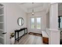 Bright and airy entryway with a console table and bench at 10401 Sunday Dr, Port Charlotte, FL 33981