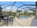 Inviting pool area with covered patio, outdoor dining, and basketball hoop at 15889 Viscount Cir, Port Charlotte, FL 33981