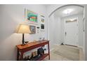Bright and airy entryway with console table and artwork at 15889 Viscount Cir, Port Charlotte, FL 33981