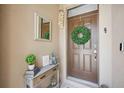 Inviting front entry with wreath and coastal decor at 15889 Viscount Cir, Port Charlotte, FL 33981