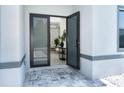 Modern front entry with glass double doors opening to a bright interior at 11042 Carnegie Ave, Englewood, FL 34224